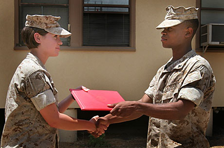 Lt. Kendra Hardesty, PAO for 1st Marine Logistics Group Public Affairs congratulates newly promoted LCpl. Jerrick Griffin at Camp Pendleton, Calif.