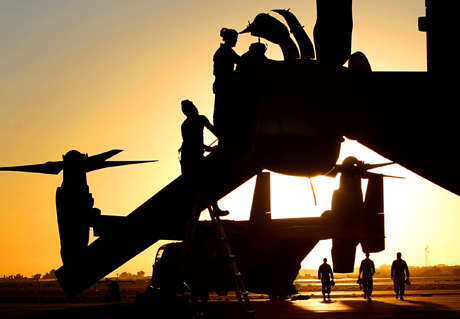 Pictorial 2nd Place - GySgt. Bill Lisbon: MV-22 Osprey pilots, crew and mechanics from New River, N.C., prepare for a night flight as the sun sets on the air station’s flight line Friday during the final exercise of the Weapons and Tactics Instructors course. The semiannual course, run by Marine Aviation and Weapons Tactics Squadron 1, ended this week. The visiting squadrons included Ospreys and Marines from Marine Medium Tiltroter Squadron’s 261 and 263 and Marine Medium Tiltroter Training Squadron 204.