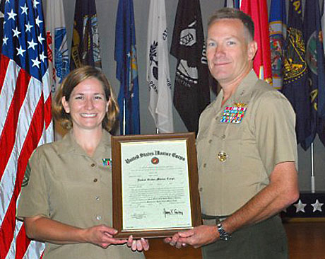 Col. Dave Lapan, Director, Defense Press Operations at the Pentagon promoted Angela Mink to gunnery sergeant July 2, at Women in Military Service for America Memorial.