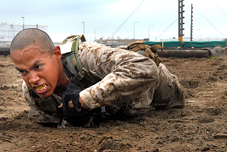 2nd Place Photojournalism by Sgt. James P.Green: Recruit Roy D. Banda, Platoon 1074, Company D, low crawls through the dirt during a transition exercise from one station to another. Low crawling helps the recruits learn how to maintain a low profile while on the move.