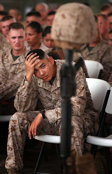 LCpl. Robert J. Ryan, a Snoqualmie, Wash., native with 8th Provisional Security Company, mourns the loss of Marine Lance Cpl. Dustin L. Canham, 21, a Lake Stevens, Wash., native and  bulk fuel specialist with 8th PSC during a memorial ceremony at Camp Lemonier, Djibouti, Mar. 28. Canham died Mar. 23 from a non-hostile incident aboard camp.