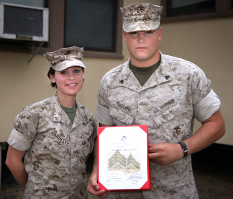 Jacob A. Singsank, combat correspondent, 1st Marine Logistics Group Public Affairs Office, is promoted to corporal by 1stLt. Kendra Hardesty, public affairs officer, 1st MLG PAO, at Camp Pendleton Aug. 10, 2009.